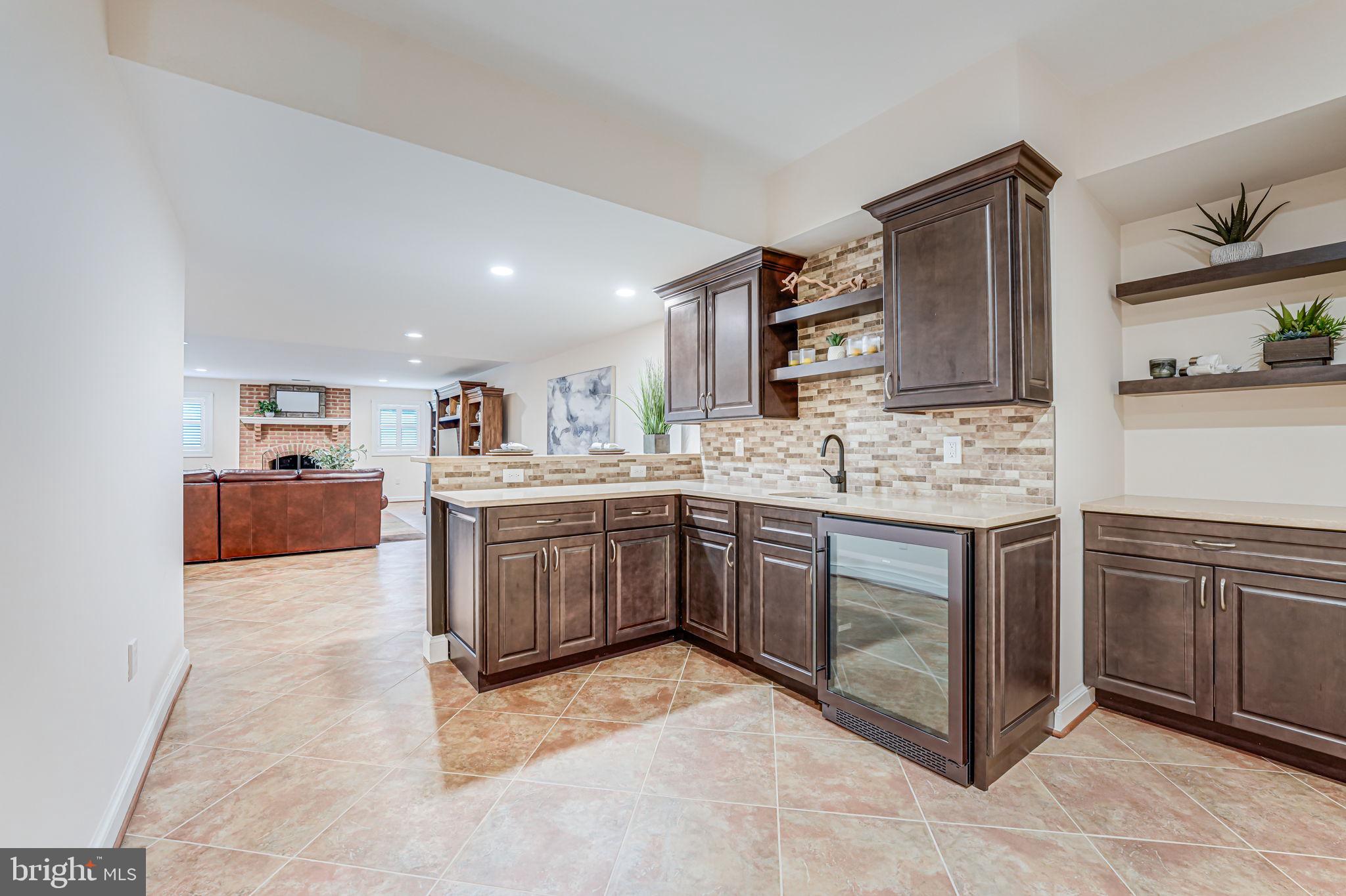 10800 Tradewind Drive Oakton, VA 22124 - Photo 55 of 77 a kitchen with stainless steel appliances granite countertop a sink and cabinets