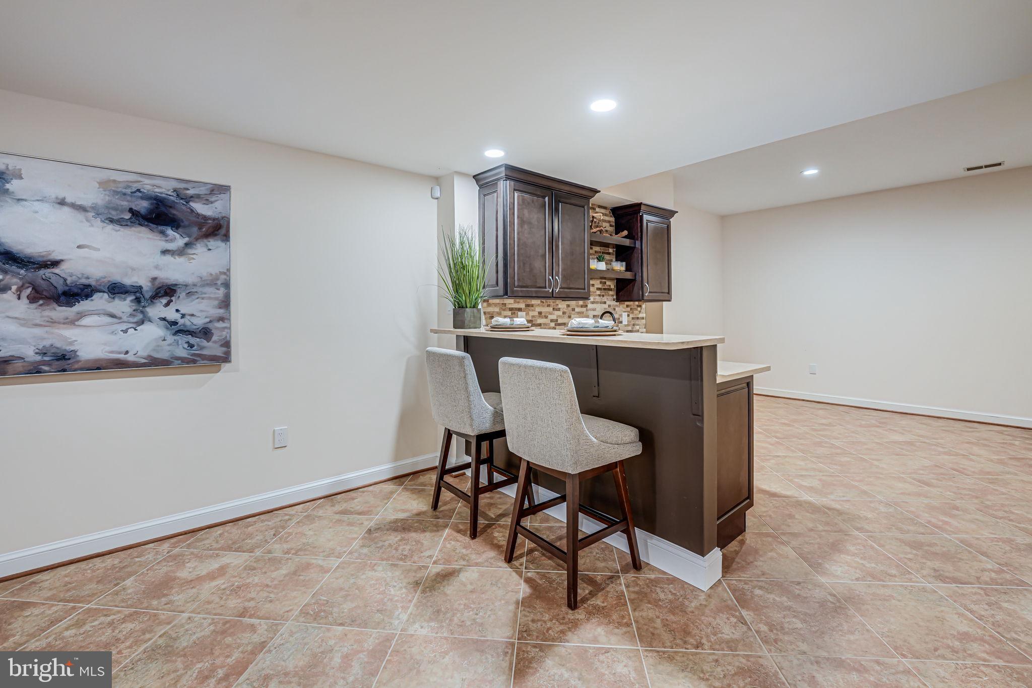 10800 Tradewind Drive Oakton, VA 22124 - Photo 56 of 77 a view of a kitchen with kitchen island a table and chairs in it