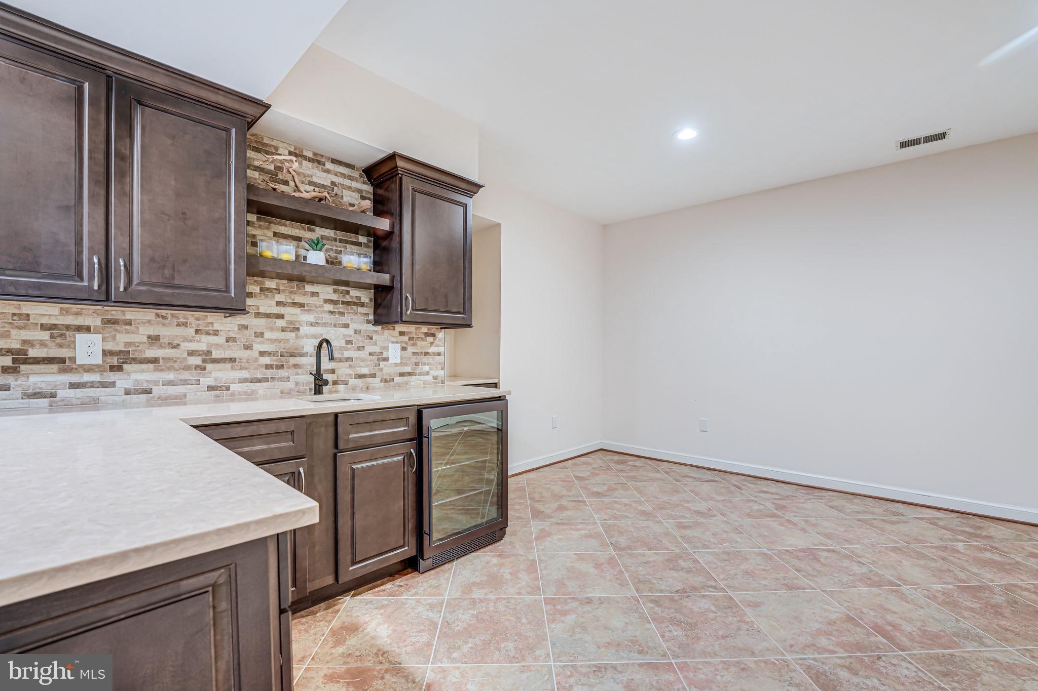 10800 Tradewind Drive Oakton, VA 22124 - Photo 57 of 77 a kitchen with stainless steel appliances a sink stove and cabinets
