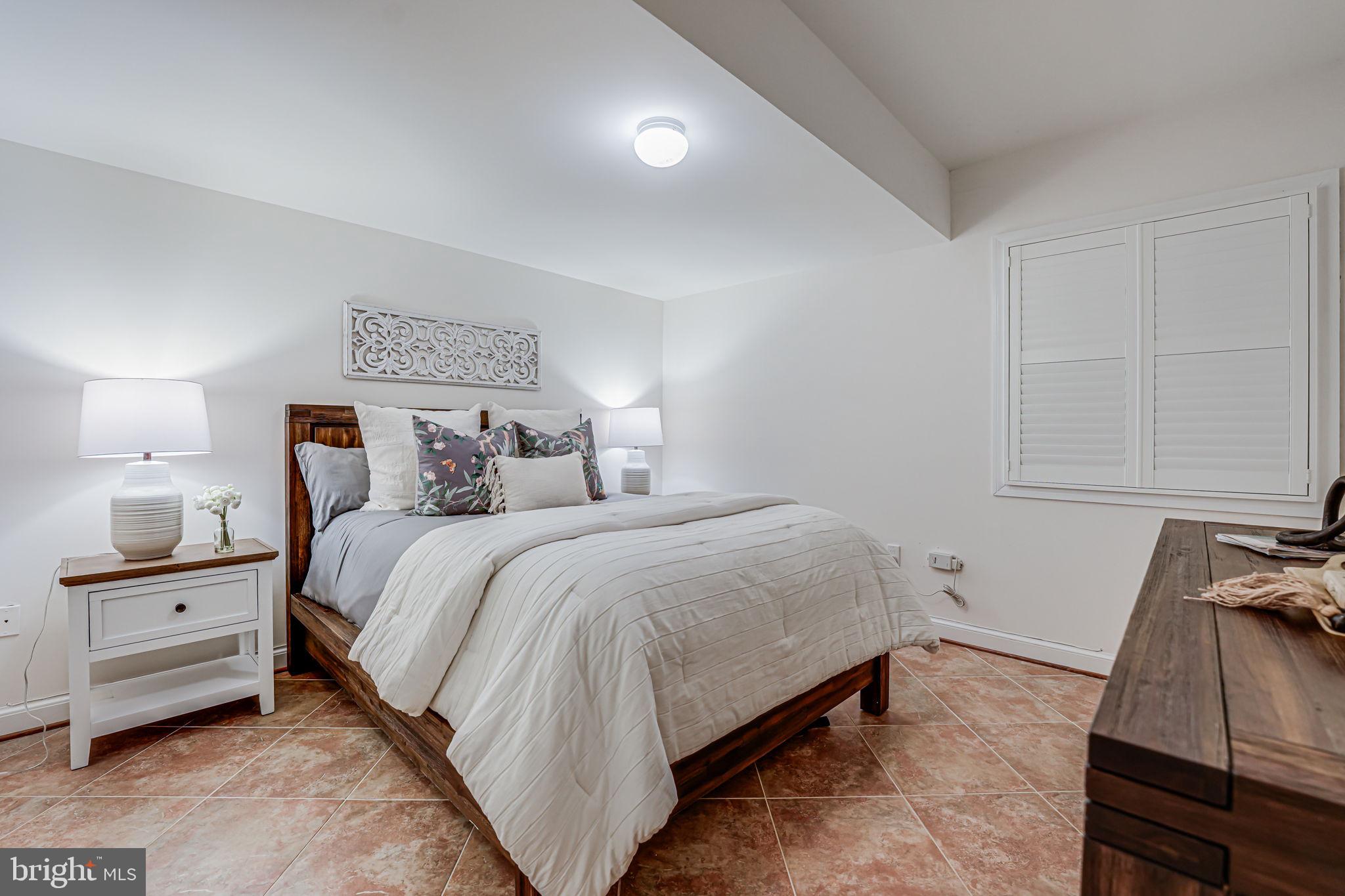 10800 Tradewind Drive Oakton, VA 22124 - Photo 59 of 77 a bedroom with a bed and a night stand