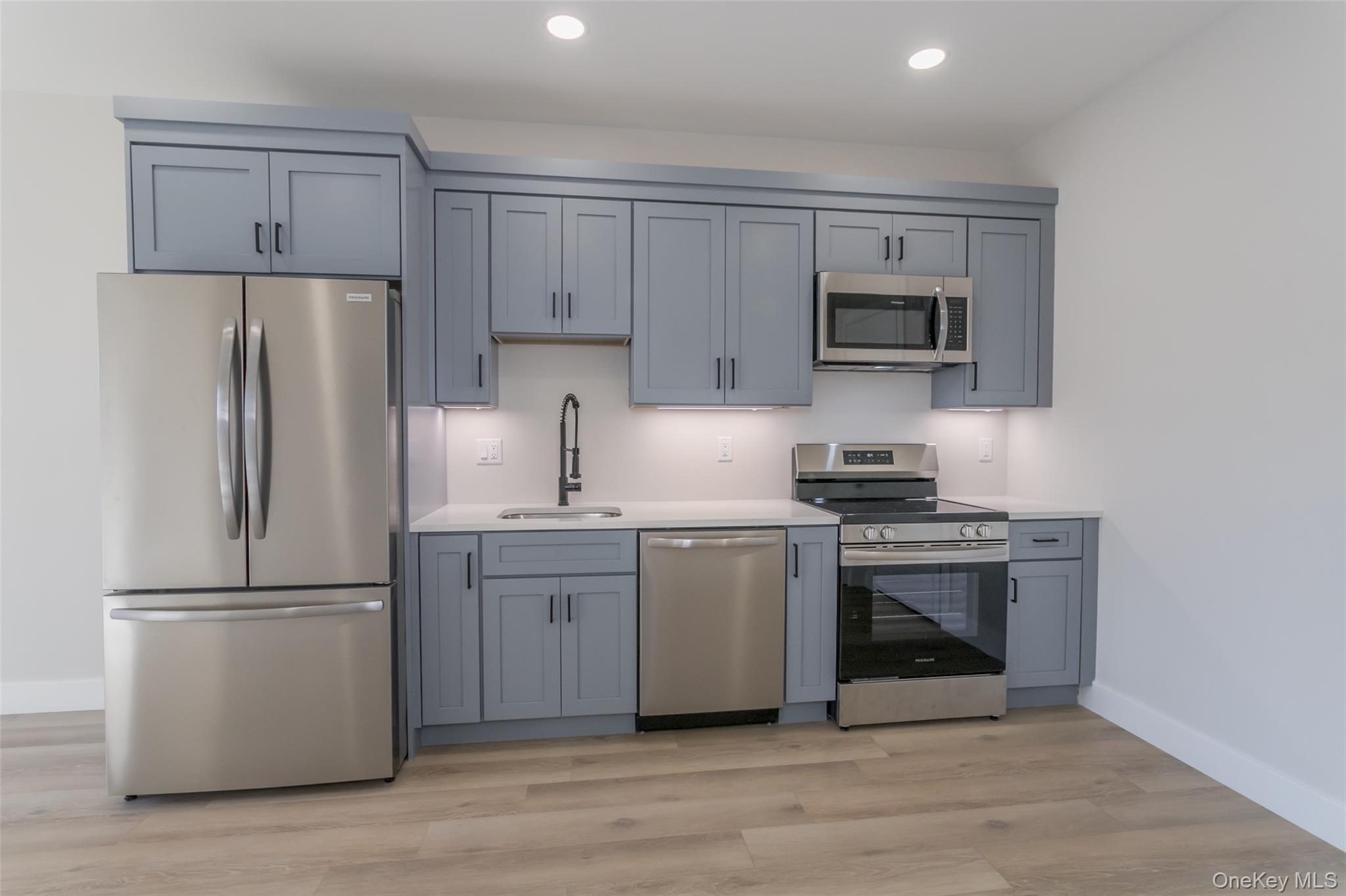 124 South Main Street, Unit 2303 Florida, NY 10921 - Photo 5 of 16 a kitchen with a refrigerator stove and white cabinets