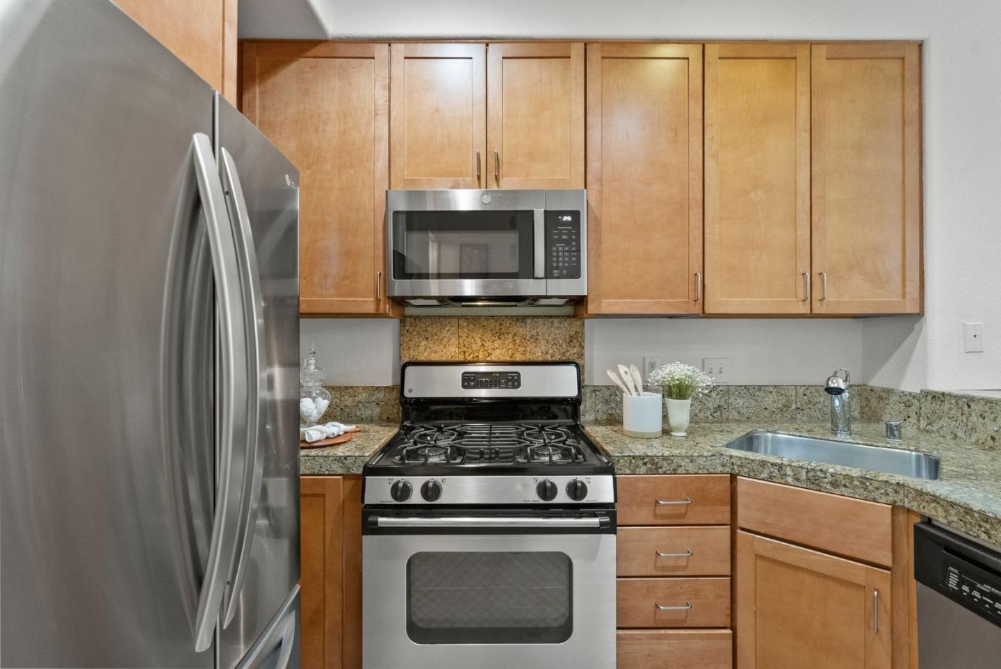 658 Kingsford Way Hayward, CA 94541 - Photo 9 of 38 a kitchen with stainless steel appliances granite countertop a stove a refrigerator and a microwave