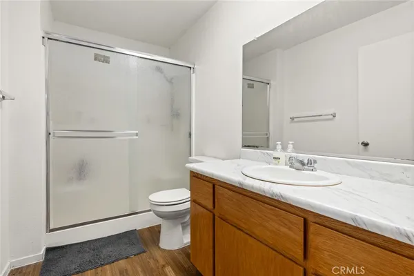 a bathroom with a granite countertop sink toilet and shower