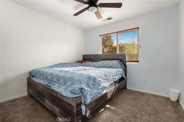 a bed sitting in a bedroom next to a window