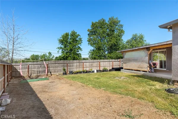 a view of a backyard with small cabin