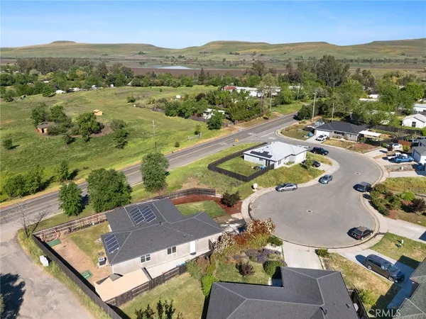 an aerial view of residential houses with outdoor space