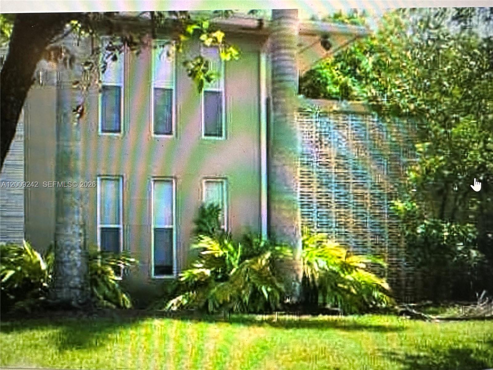 6310 Southwest 79th Street, Unit 1 South Miami, FL 33143 - Photo 1 of 8 a front view of a house with a yard
