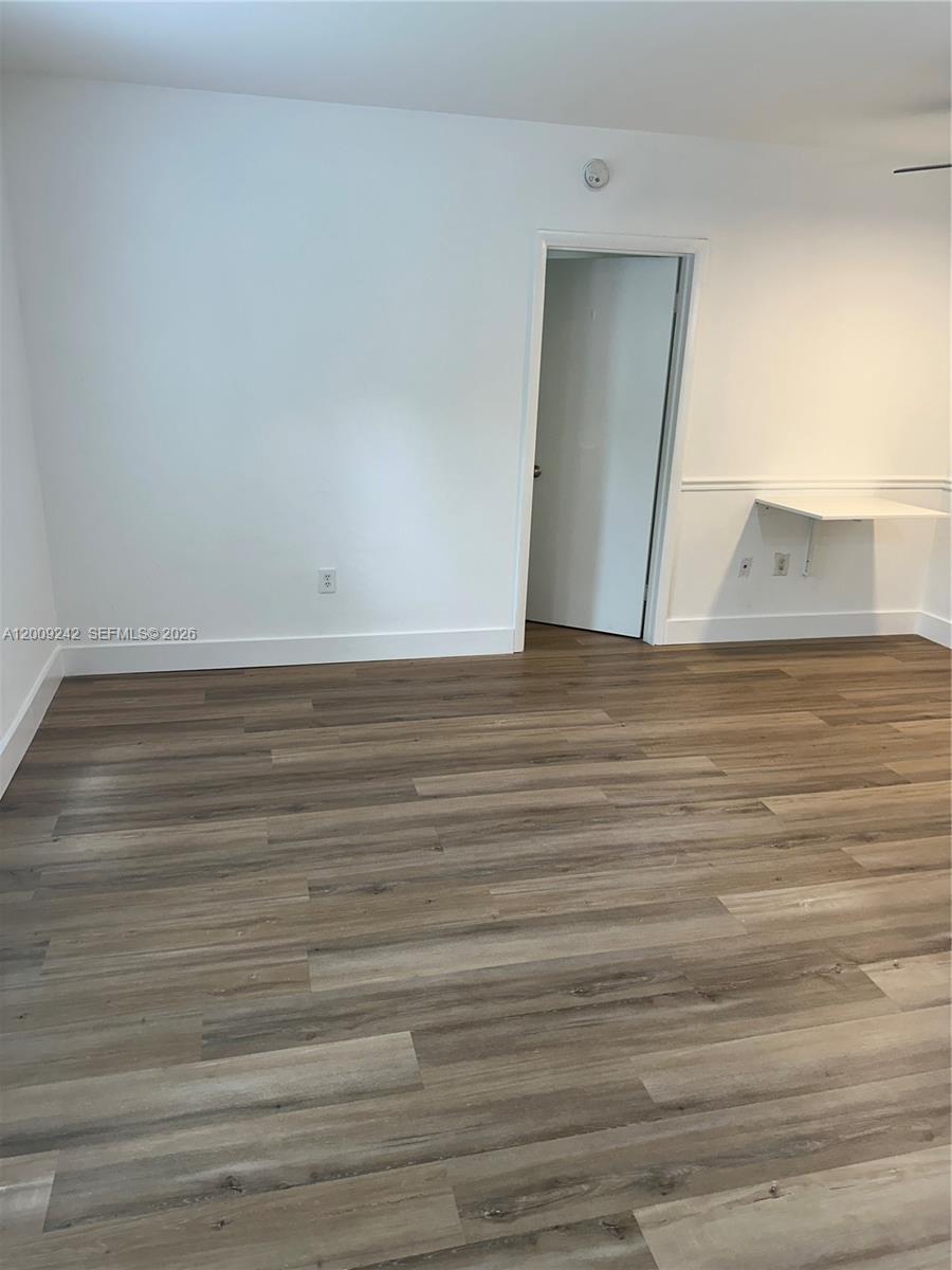 6310 Southwest 79th Street, Unit 1 South Miami, FL 33143 - Photo 8 of 8 a view of a room with wooden floor