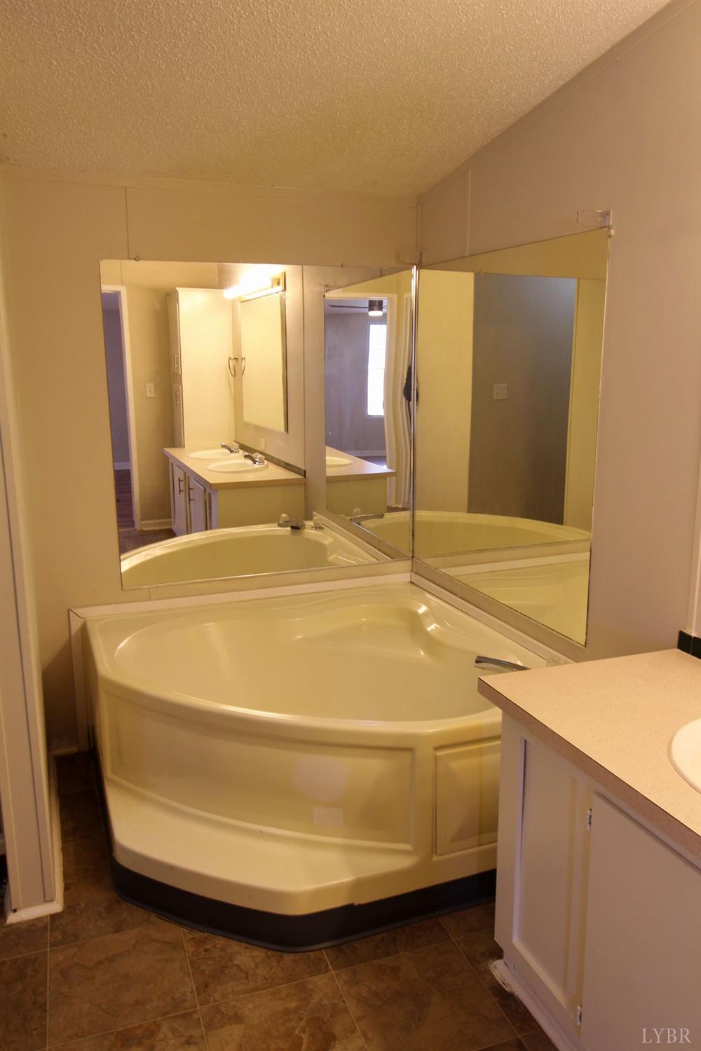 1908 Holiday Lake Road Appomattox, VA 24522 - Photo 19 of 35 a bathroom with a sink and a mirror