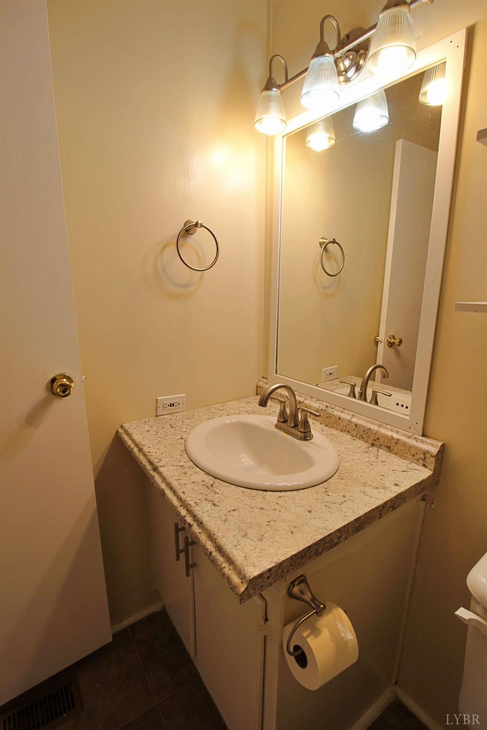 1908 Holiday Lake Road Appomattox, VA 24522 - Photo 25 of 35 a bathroom with a sink and a mirror