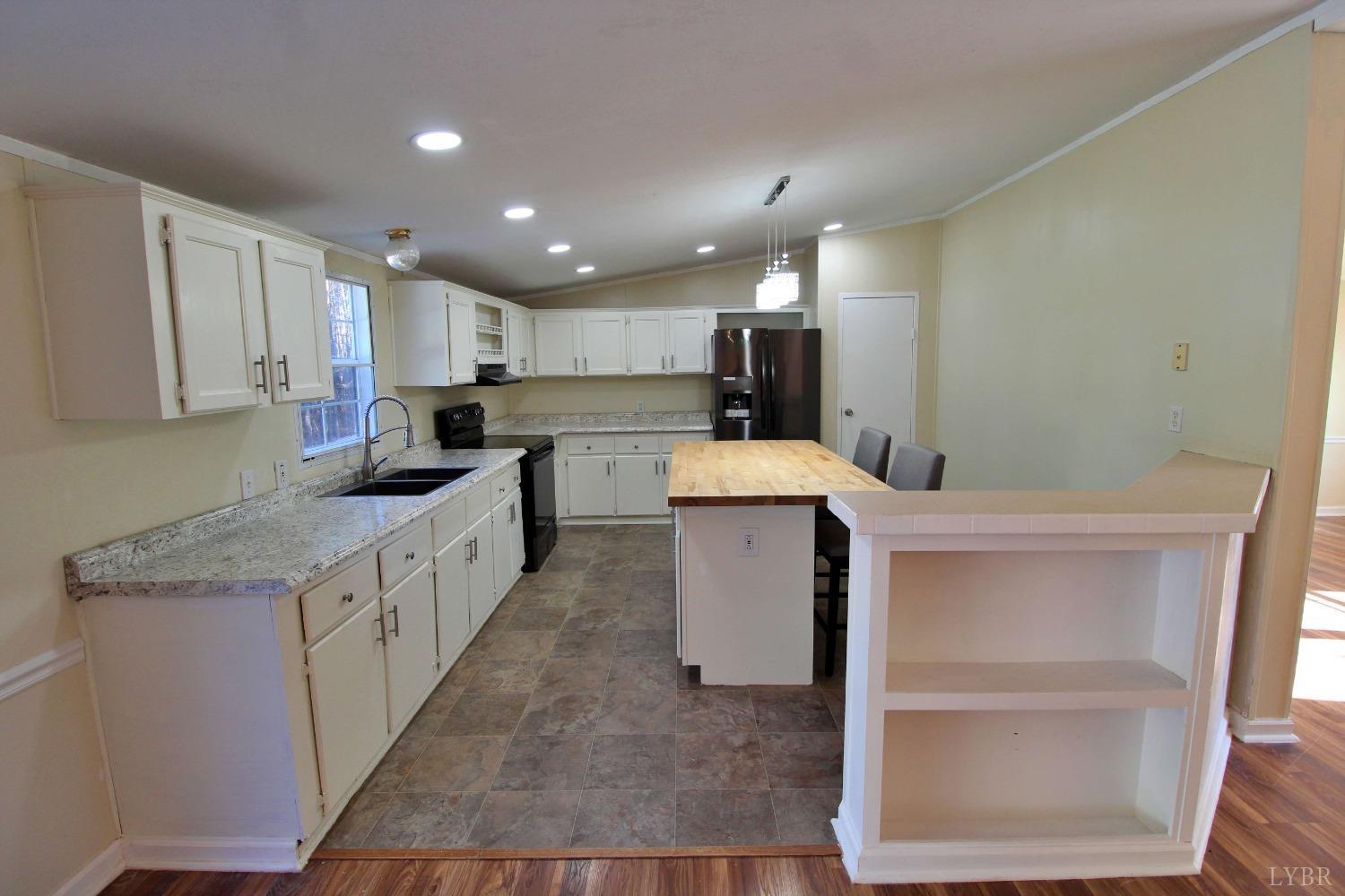 1908 Holiday Lake Road Appomattox, VA 24522 - Photo 4 of 35 a kitchen with a sink microwave and cabinets