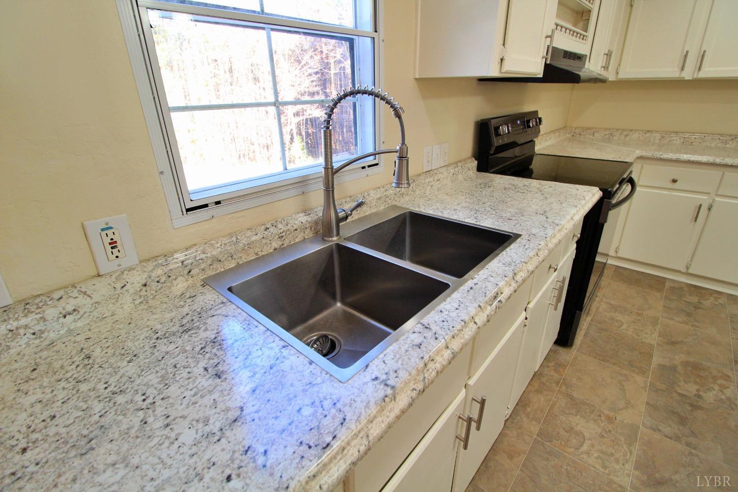 1908 Holiday Lake Road Appomattox, VA 24522 - Photo 6 of 35 a kitchen with a stove a sink and a microwave