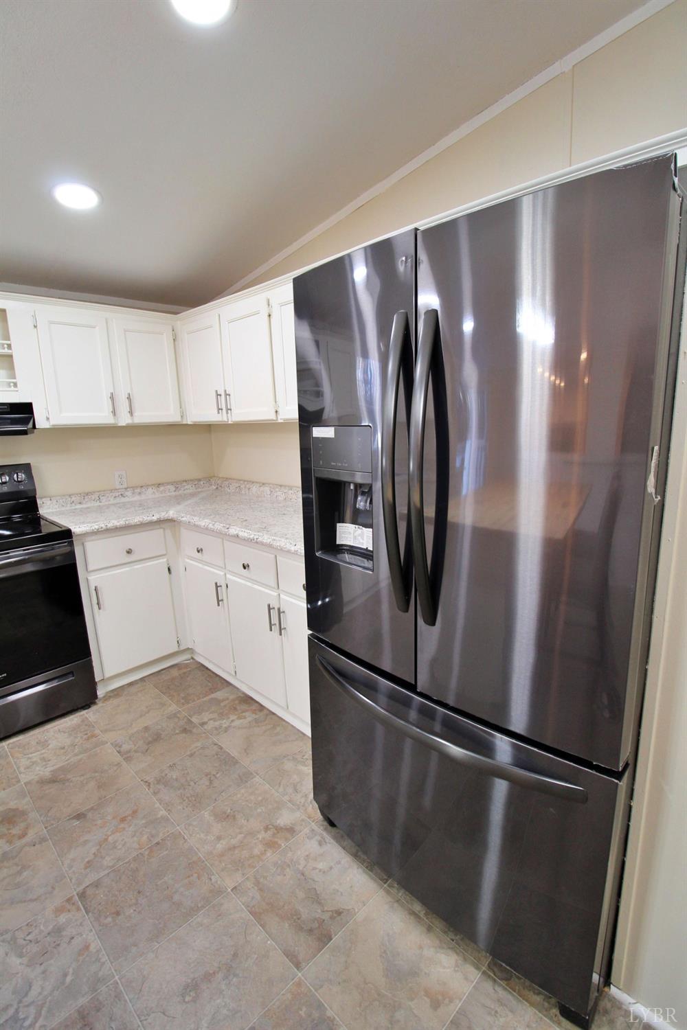 1908 Holiday Lake Road Appomattox, VA 24522 - Photo 7 of 35 a kitchen with stainless steel appliances granite countertop a refrigerator and a stove top oven