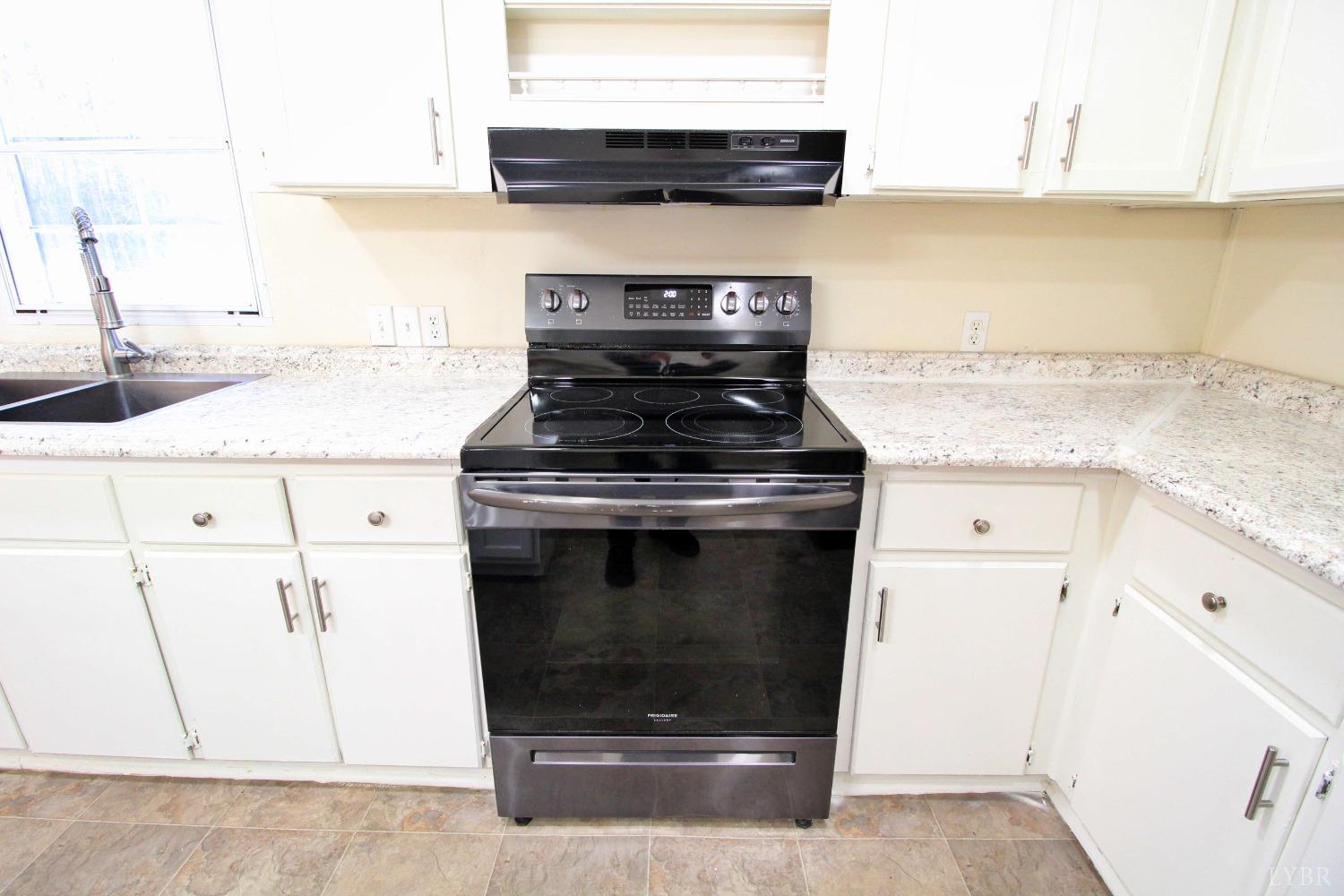 1908 Holiday Lake Road Appomattox, VA 24522 - Photo 8 of 35 a stove top oven sitting inside of a kitchen