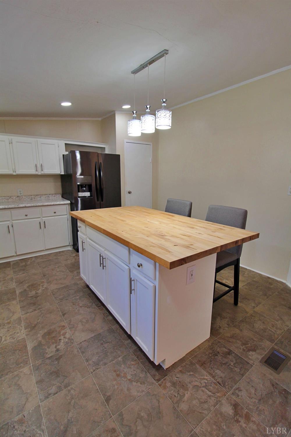 1908 Holiday Lake Road Appomattox, VA 24522 - Photo 10 of 35 a large kitchen with a table and chairs