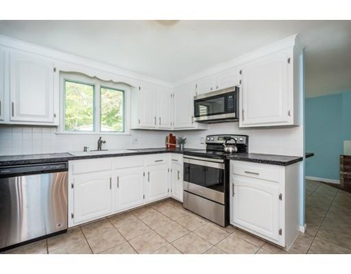 100 Carpenter Road Northbridge, MA 01588 - Photo 7 of 32 a kitchen with stainless steel appliances granite countertop a stove a sink and white cabinets
