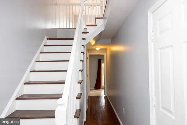a view of staircase with white walls and windows