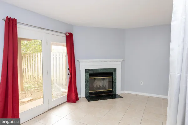 a living room with a fireplace and a large window