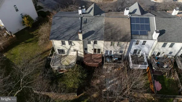 an aerial view of a house with garden space and parking