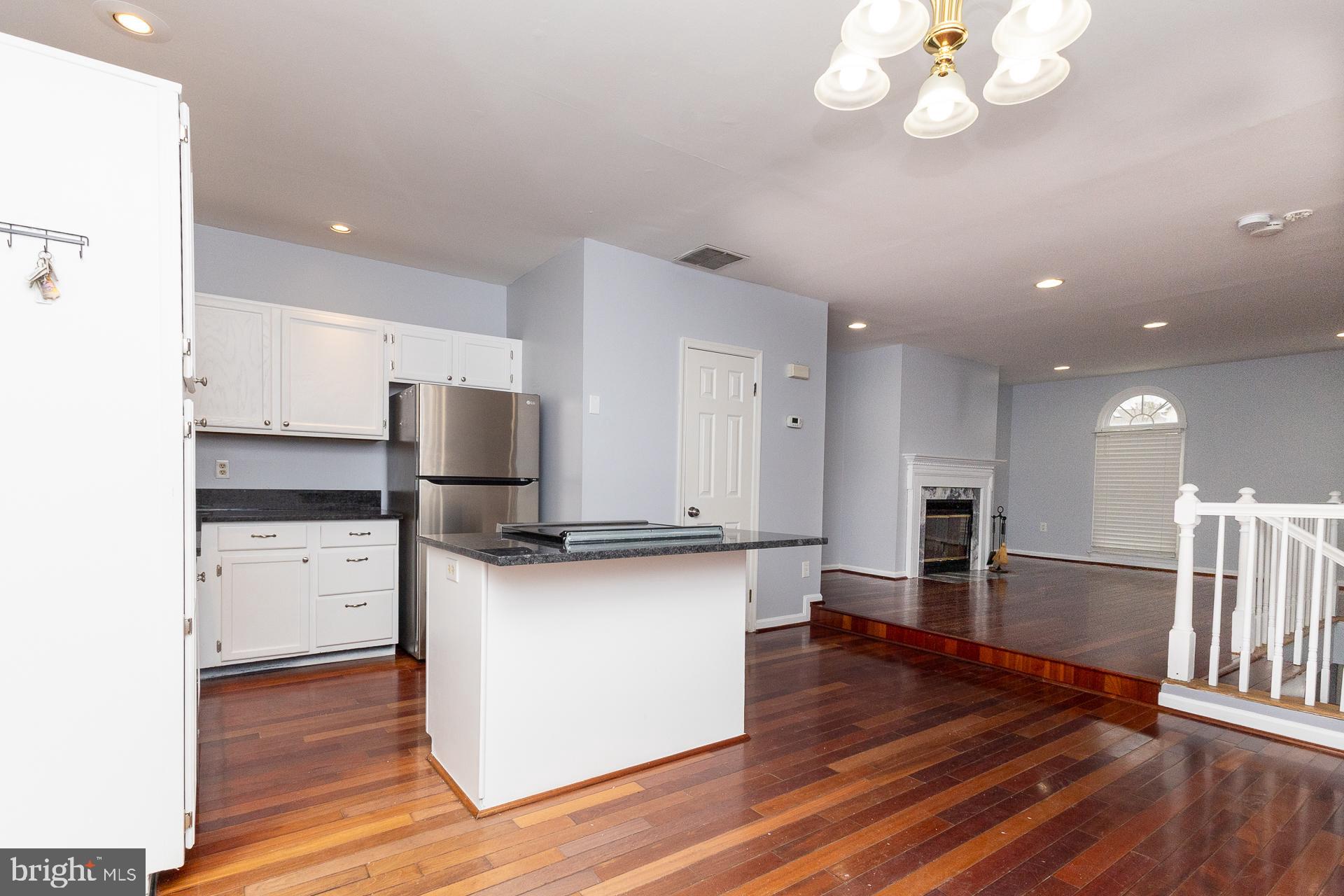 58 Victoria Square Frederick, MD 21702 - Photo 4 of 26 a kitchen with stainless steel appliances a stove top oven and cabinets