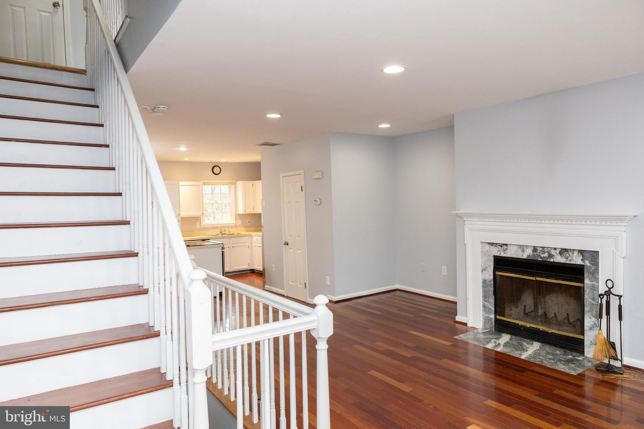 58 Victoria Square Frederick, MD 21702 - Photo 6 of 26 a view of an empty room with wooden floor fire place