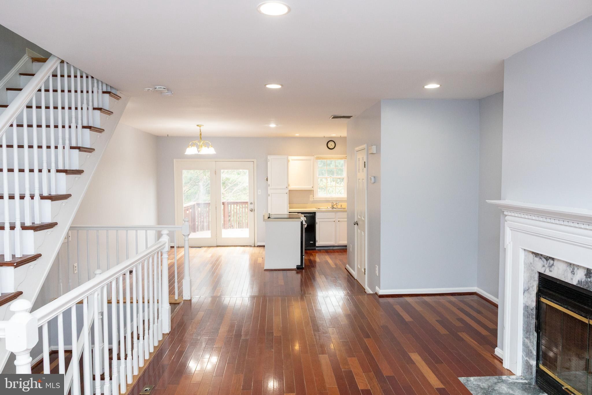 58 Victoria Square Frederick, MD 21702 - Photo 8 of 26 a view of a living room with wooden floor and a fireplace