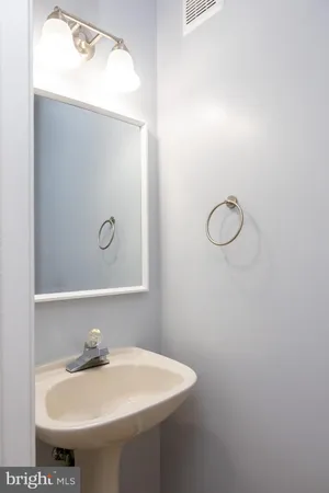 a bathroom with a sink and mirror