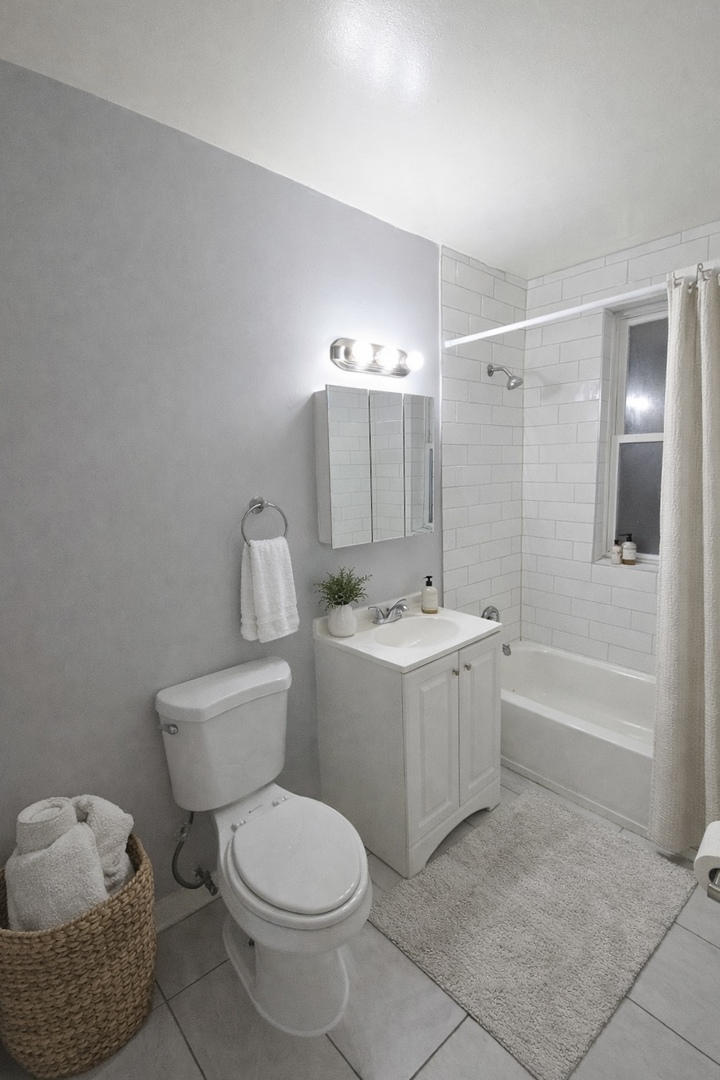 5701 West Roosevelt Road, Unit 3W Cicero, IL 60804 - Photo 4 of 8 a spacious bathroom with a toilet a sink and bathtub