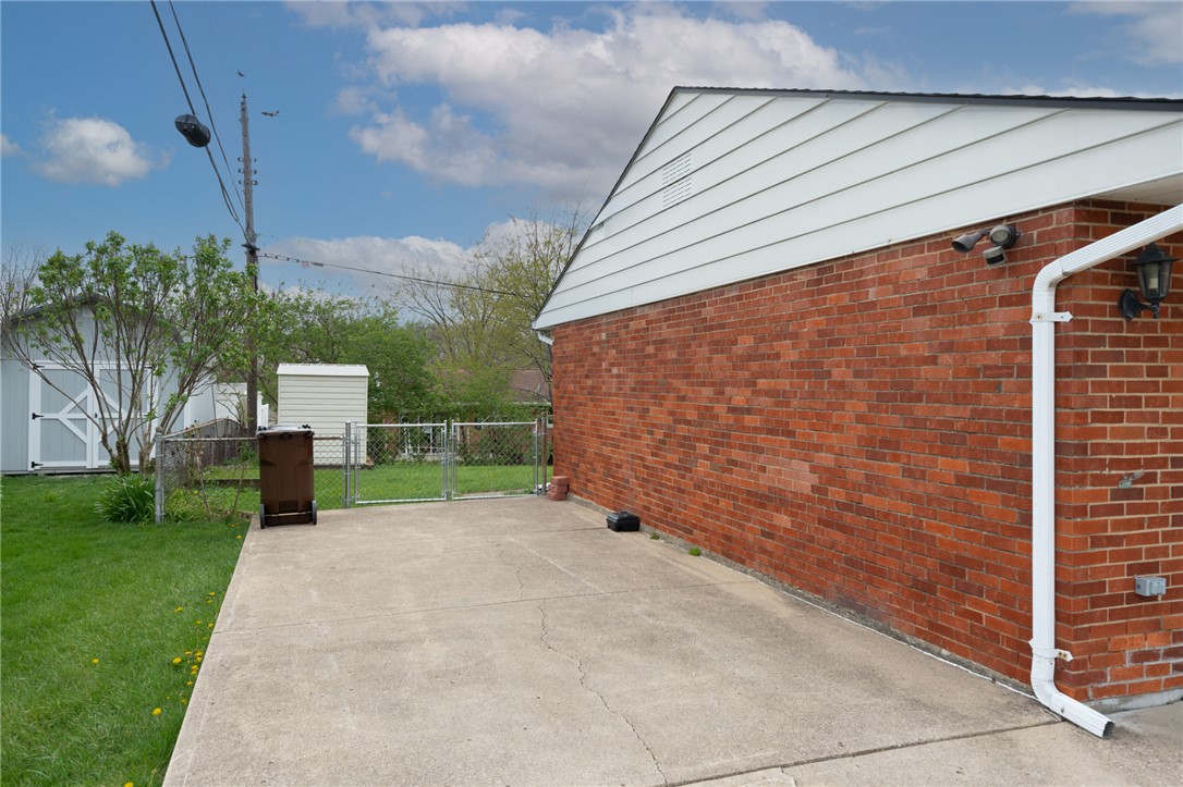 795 Spring Garden Place Dayton, OH 45431 - Photo 9 of 34 This outdoor space offers a paved driveway, a sturdy fence, and a convenient shed.