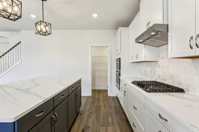 a kitchen with a sink cabinets and window