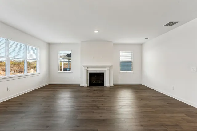 a view of a kitchen with wooden floor and stairs
