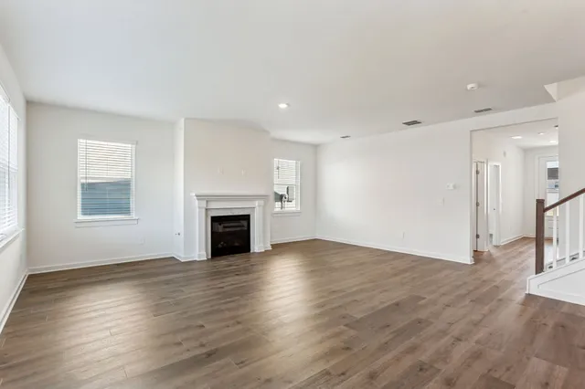 a view of a kitchen with wooden floor and electronic appliances