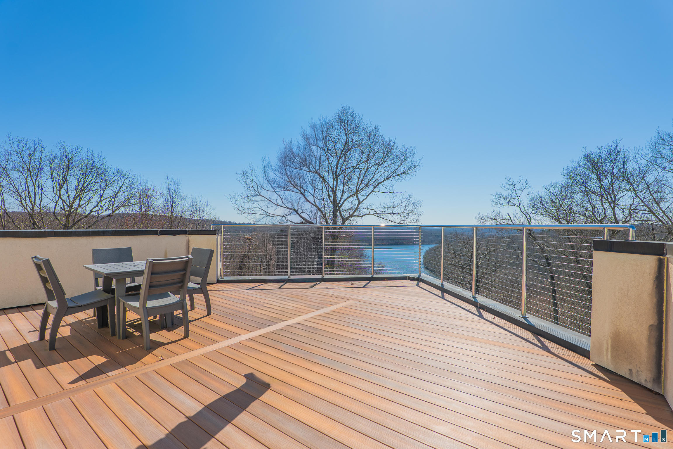 216 Kuhne Road Southbury, CT 06488 - Photo 3 of 40 a patio with table and chairs and potted plants with wooden floor and fence