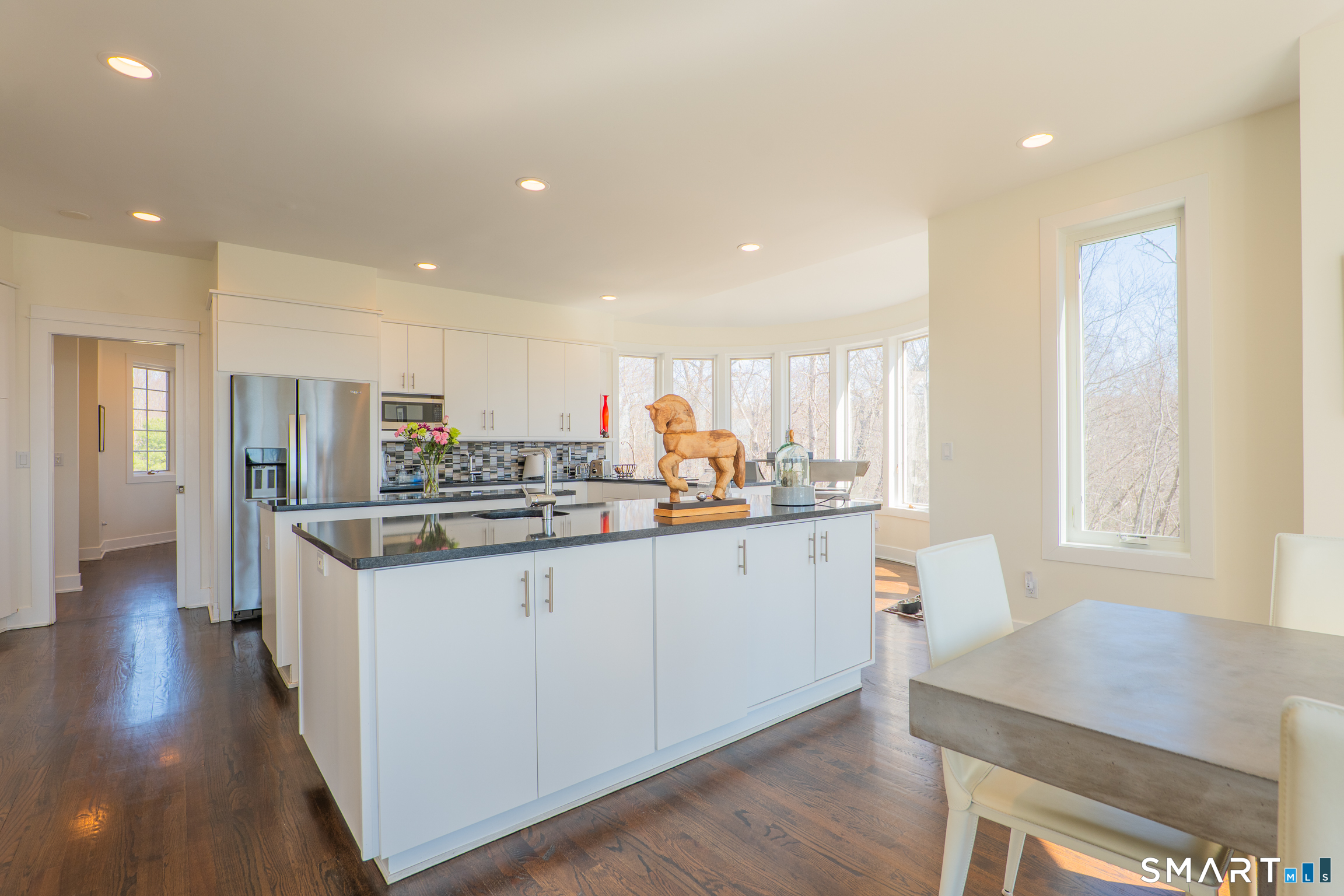 216 Kuhne Road Southbury, CT 06488 - Photo 7 of 40 a kitchen with stainless steel appliances granite countertop a stove a sink a refrigerator and white cabinets with wooden floor