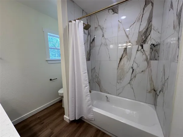 a bathroom with a bathtub and a shower