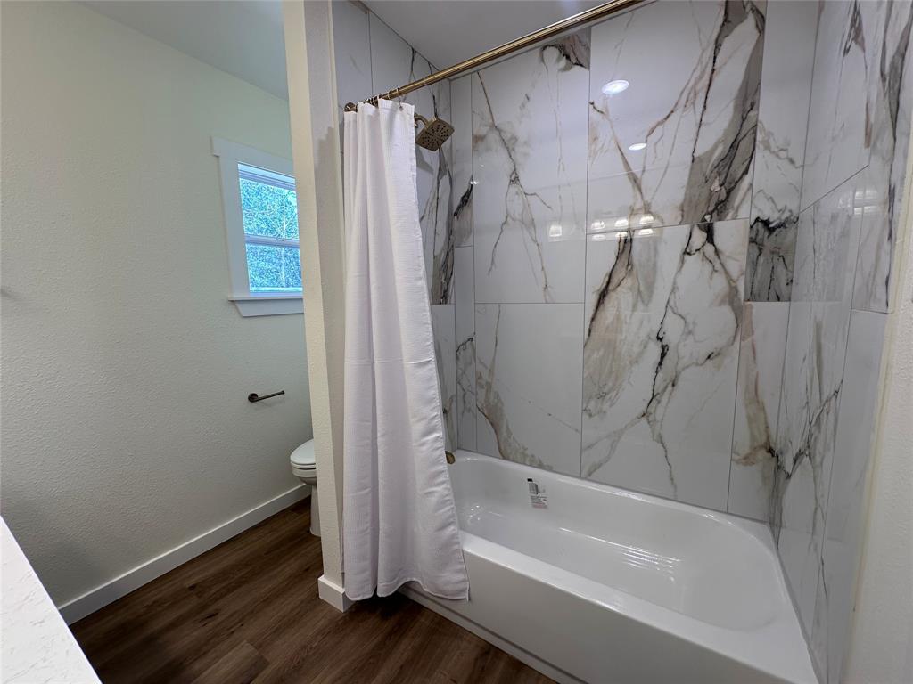 706 Barbara Street Athens, TX 75751 - Photo 11 of 13 a bathroom with a bathtub and a shower
