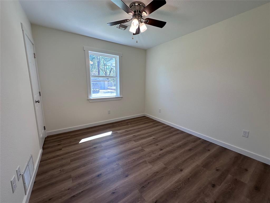 706 Barbara Street Athens, TX 75751 - Photo 6 of 13 a view of an empty room with window and wooden floor