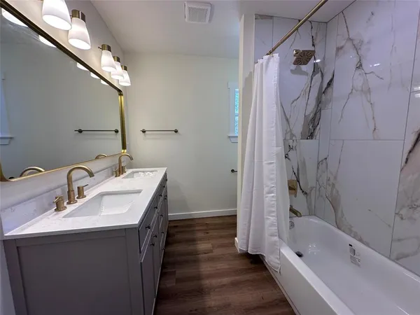 a bathroom with a sink a mirror and a bathtub