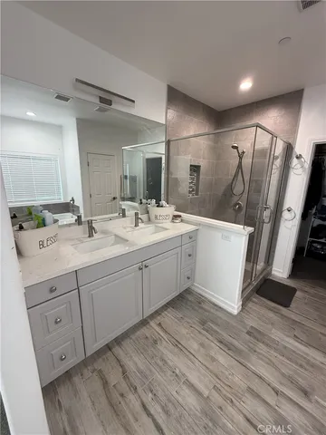 a bathroom with a double vanity sink and mirror