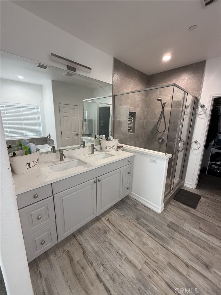 9591 Burbank Road Phelan, CA 92371 - Photo 5 of 11 a bathroom with a double vanity sink and mirror