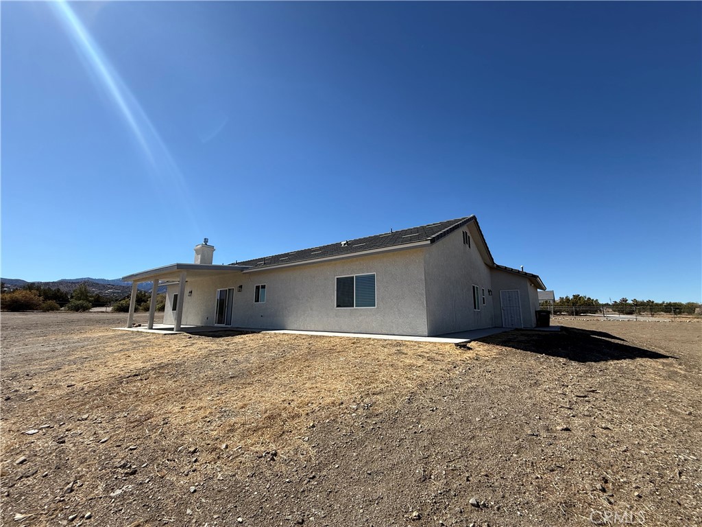 9591 Burbank Road Phelan, CA 92371 - Photo 10 of 11 a view of a house with a yard
