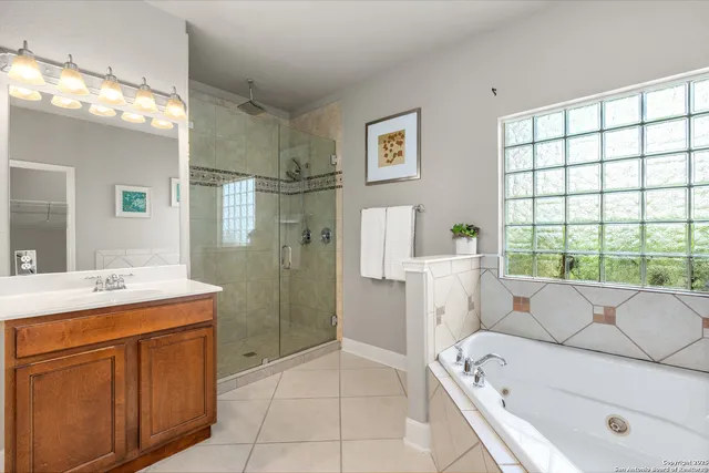a bathroom with a granite countertop sink a toilet and shower