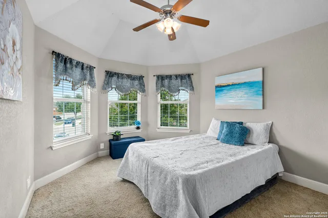 a bedroom with a large bed and a window