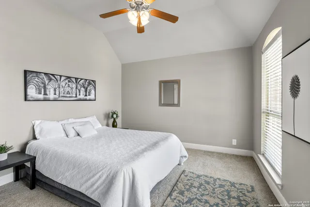 a bedroom with a large bed and a window