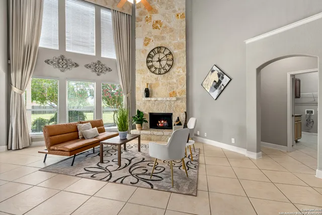 a living room with furniture a fireplace and a table