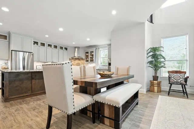 a living room with furniture a dining table and kitchen view