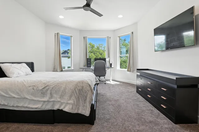 a bedroom with a bed and flat screen tv