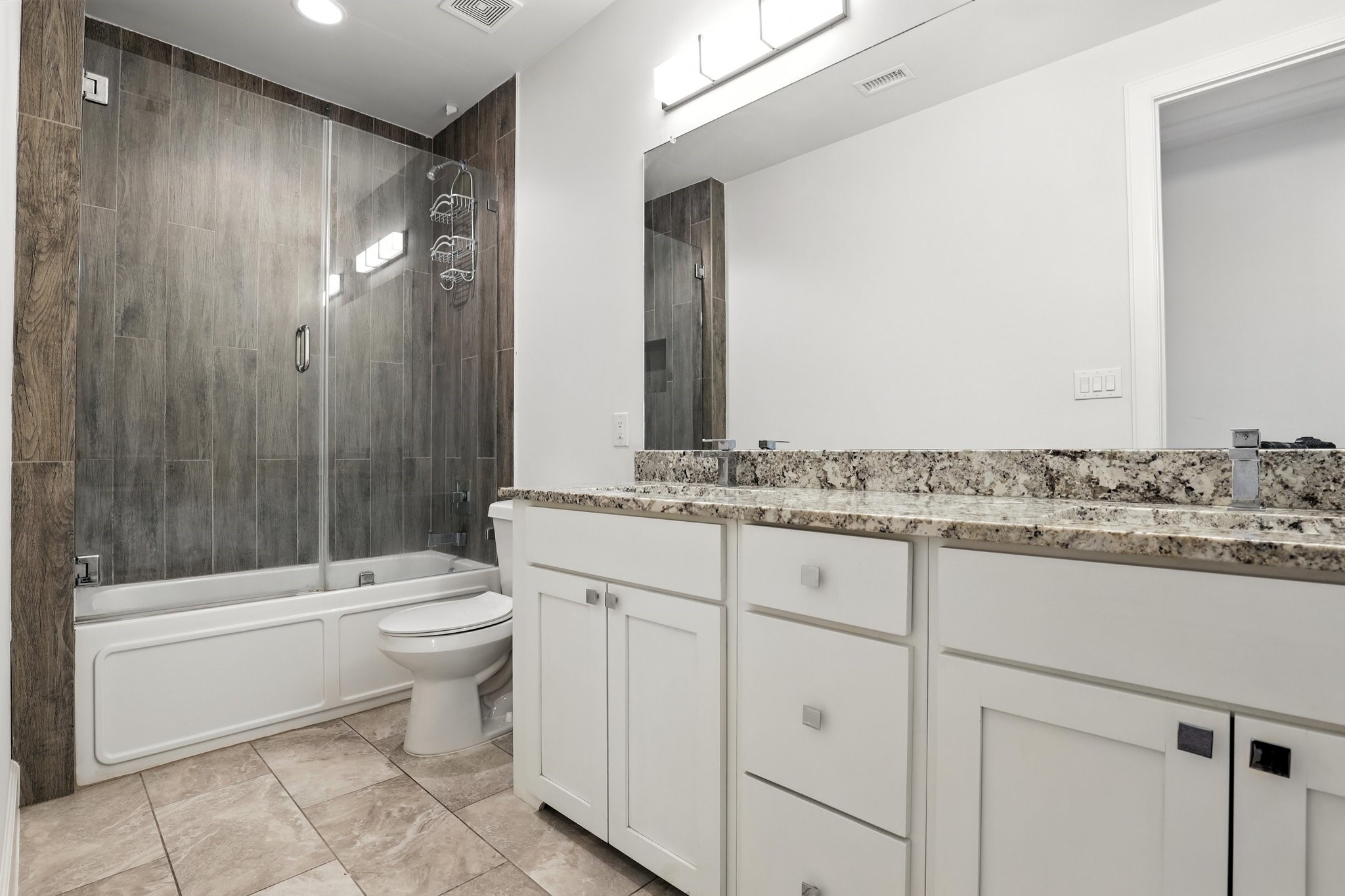 3202 Ozark Street Houston, TX 77021 - Photo 27 of 37 a bathroom with a granite countertop toilet a sink and a mirror