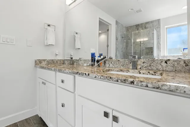 a bathroom with double sink and a mirror