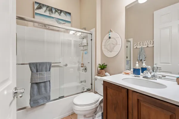a bathroom with a granite countertop toilet sink and shower